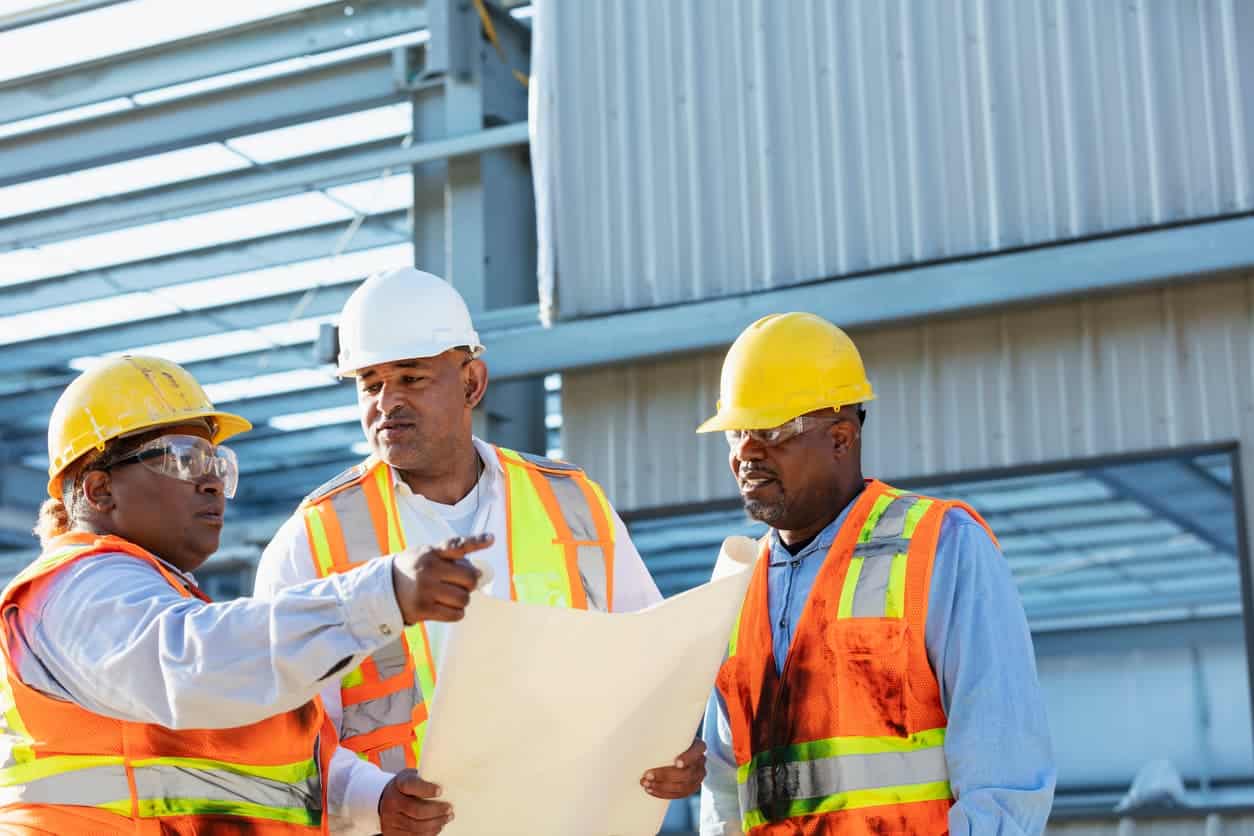 Workers discussing construction staffing solutions