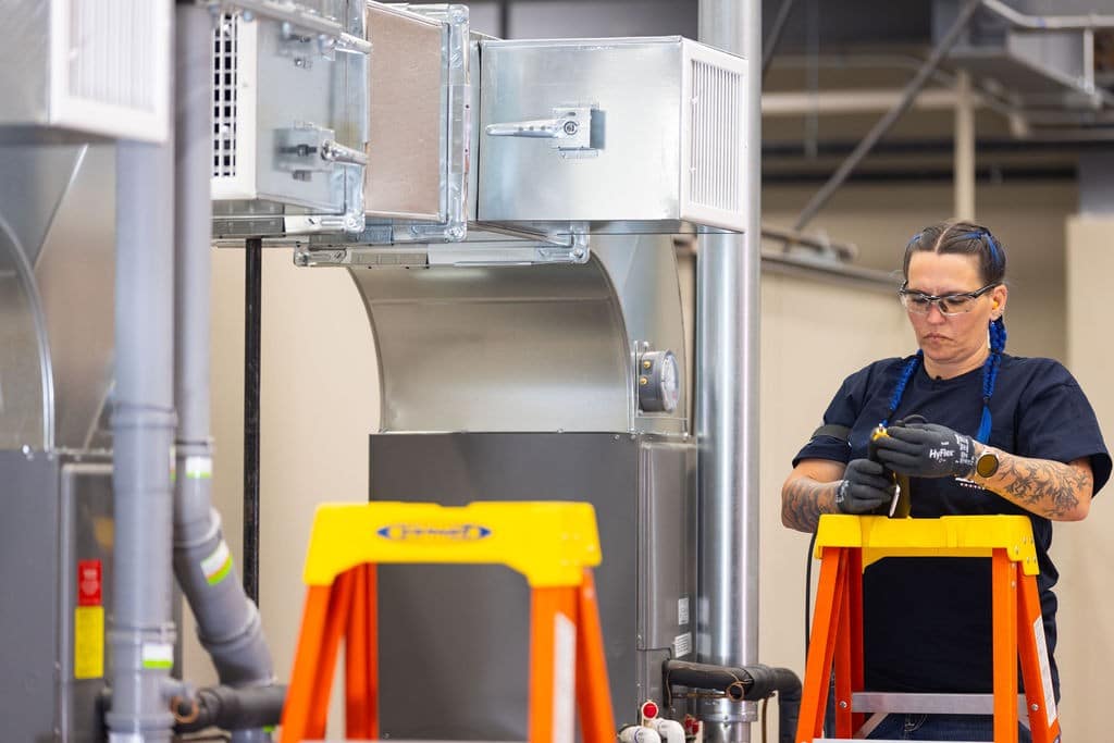 person checking her tools while do skilled labor work